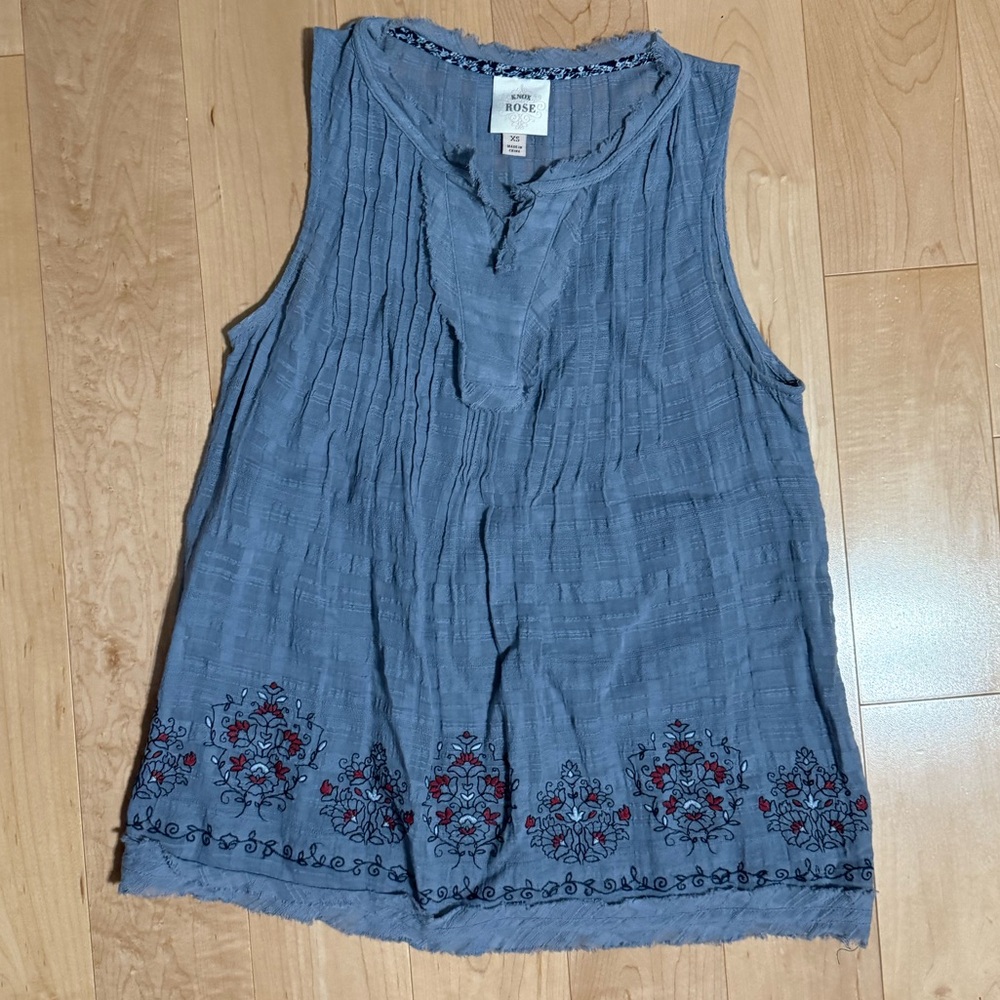 Flowy blue tank with detailed design.